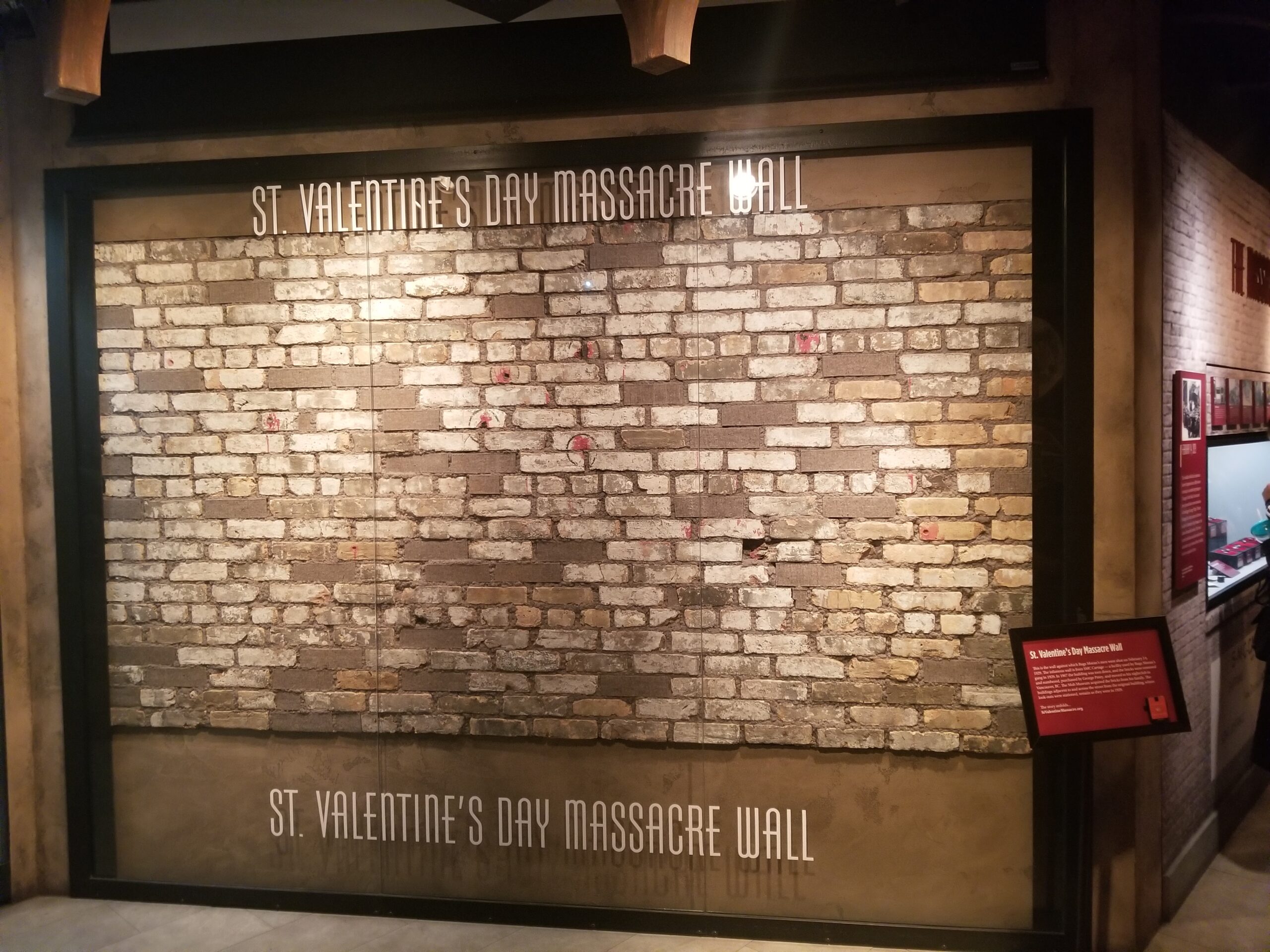 This image shows the St. Valentine's Day Massacre wall that is on display in the Mob Museum in Las Vegas. The actual bullet holes are visible when seen up close.